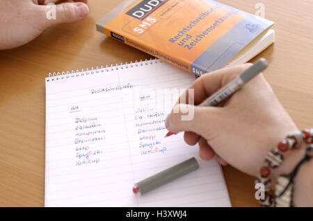 Spelling reform, schoolboy, detail, hand, Duden, block, comparison, manner writing, old, anew, pen, curled spelling, orthography, language, German, regulation, reform, update, updates, look up, look, confusion, writing pad, words, book, reference book, ru Stock Photo