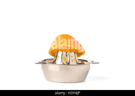 Cutout of half an orange on a stainless steel hand juicer Stock Photo
