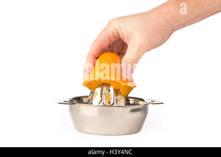 Cutout of hand extracting an orange in stainless steel citrus juicer. Stock Photo