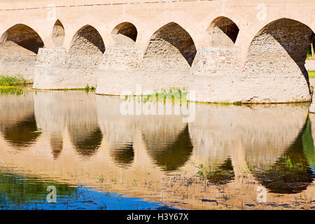 blu in iran  the old bridge and the river antique construction near nature Stock Photo