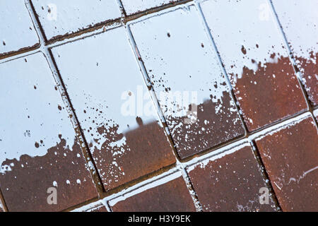 Close up of abstract blurs patterns textures and grunge and blue sky reflections on wet pavement tiles background Stock Photo