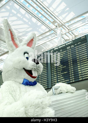 Airport, terminal, Easter bunny, happy, suitcase, portrait, side view, Easter, Easter feast, child's faith, lining, panels, costume, hare's costume, hare, humor, fun, funnily, friendly, joy, Easter vacation, vacation, travel, journey by air, go away, East Stock Photo
