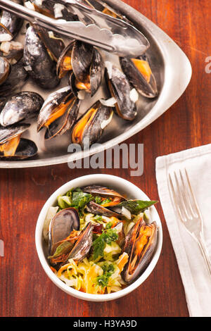 Roasted clams with asian coleslaw. Seafood dish served. Rustic gourmet shellfish dinner. Stock Photo