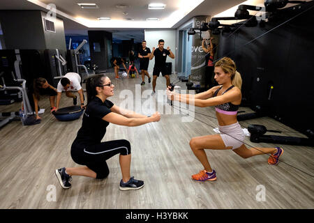 Personal trainer in the gym with a client Stock Photo