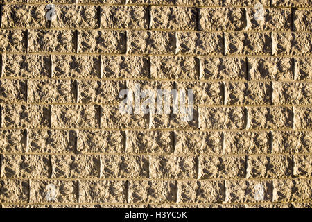 Wall of structured decorative light bricks as background or texture in natural sunlight Stock Photo