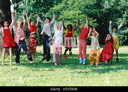 Meadow, children, group, skin colour differently, caper, fun, summer, outside youth, childhood, friends, friendship, boy, girl, hand in hand, nationality, passed away, difference, game, leisure time, amusement, melted, lighthearted, jump, play, crack Stock Photo
