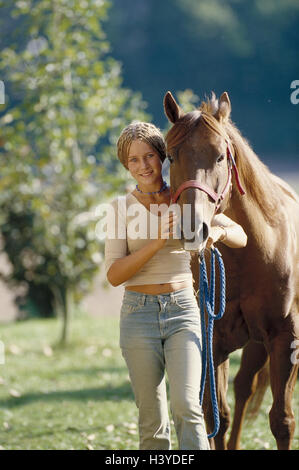 Young persons, horse, lead, walk, detail, riding horse, mammal, benefit animal, teenager, girl, hairstyle, little plait, horse's head, touch, touch, animal-loving, animal-loving, respect, trust, horse-riding, rider, horse's owner, horse's owner, smile, ha Stock Photo