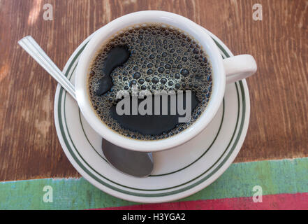 Cup of black coffee with bubbles Stock Photo