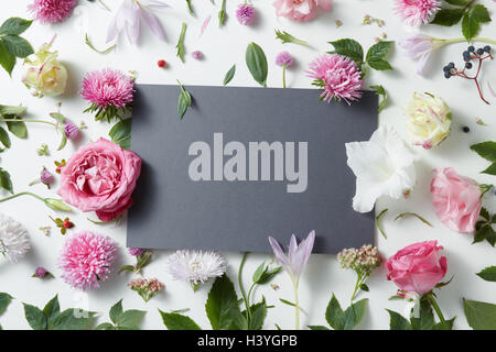 Beautiful pink and white flowers with empty notebook Stock Photo