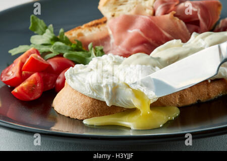 Poached eggs on buttered wholemeal toast breakfast. Stock Photo