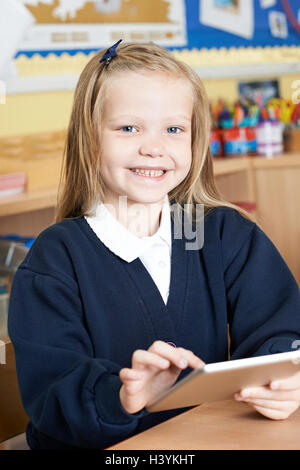 Female Elementary School Pupil Using Digital Tablet In Class Stock Photo