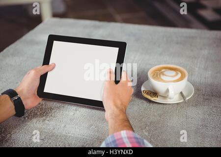 Hands of man holding digital tablet Stock Photo