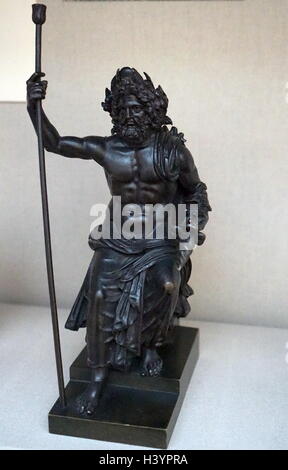 Roman statuette in bronze showing the God Jupiter. 1st - 2nd century AD. from Hungary. Depicting grasping sceptre and thunderbolt. Stock Photo