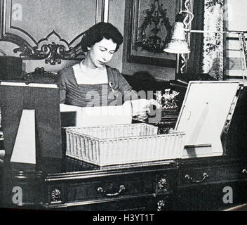 Photograph of Queen Elizabeth II (1926 -) at her desk. Dated 20th Century Stock Photo