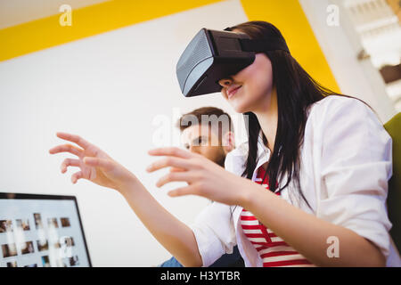Low angle view of executive enjoying augmented reality headset at creative office Stock Photo
