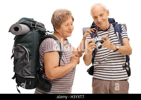 Senior hikers looking at a photograph on a camera isolated on white background Stock Photo