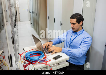 Technician working on laptop Stock Photo