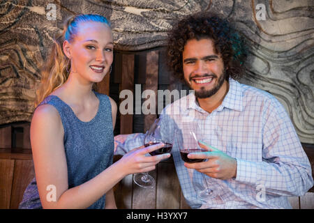 Couple toasting glass of wine in bar Stock Photo