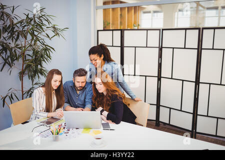 Creative business people using laptop in meeting room Stock Photo