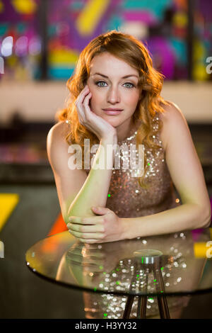 Portrait of young woman leaning on table Stock Photo