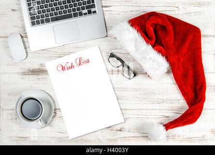Office Workplace with Christmas Decoration. Business Holidays Concept with sample text Wish List Stock Photo