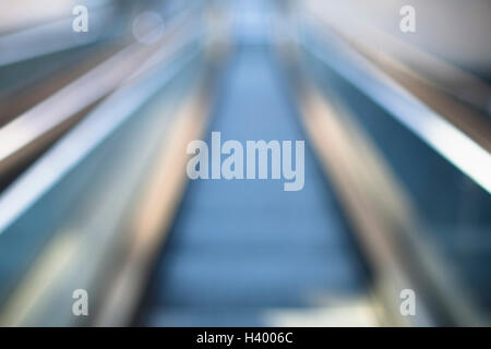 Defocused image of escalator in building Stock Photo
