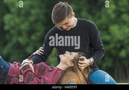 Happy woman lying on boyfriend's lap at park Stock Photo