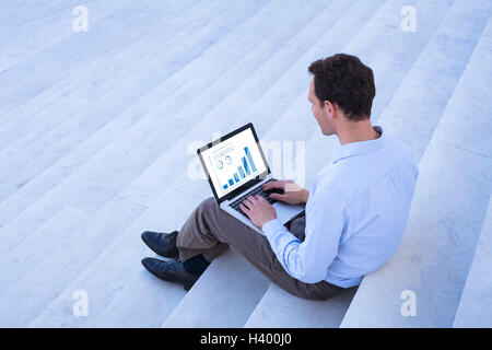 Working on financial data with laptop outdoors Stock Photo