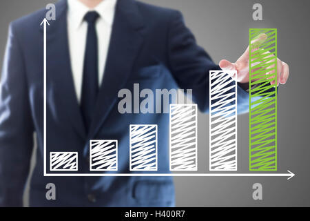 Businessman presenting a successful sustainable development on a bar chart Stock Photo