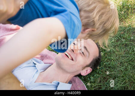 High angle view of cheerful father lifting son in park Stock Photo