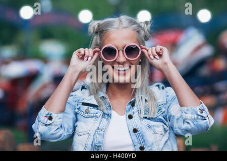 Portrait of happy fashionable young woman wearing sunglasses Stock Photo