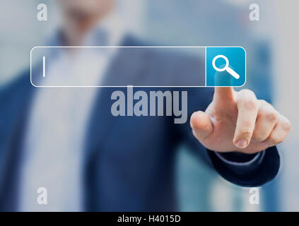 Search button on virtual screen pressed with finger Stock Photo