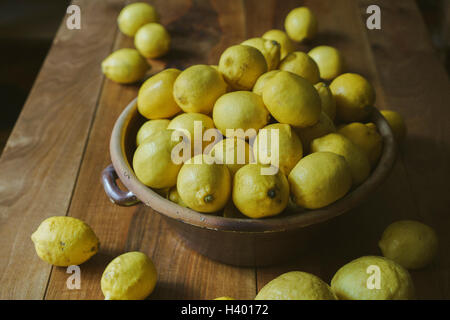Close-up of lemons in container on table Stock Photo