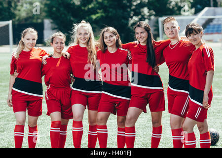Portrait of smiling soccer players standing on field Stock Photo