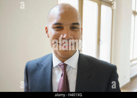 Portrait of confident smiling businessman standing at creative office Stock Photo