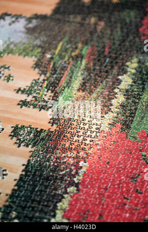 High angle view of incomplete jigsaw puzzle on wooden table Stock Photo