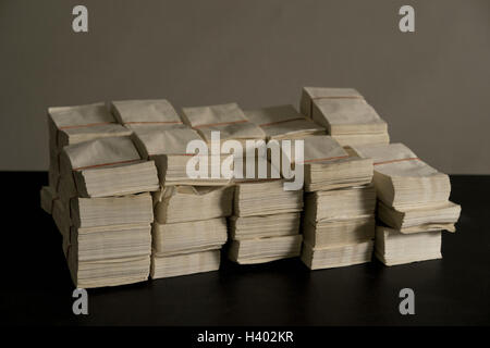 Stack of envelopes on table against wall Stock Photo