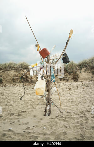 Bottles on wooden post at beach against sky Stock Photo