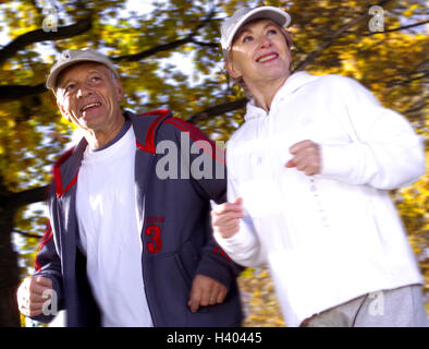 Park, Senior couple, jogging, detail, autumn, 55-65 years, couple, senior citizens, Best Agers, Jung-remaining, jogger, sportsman, partnership, respect, jog, run, sport, running, motion, sportily, fitness, activity, leisure time, hobby, health, conscious Stock Photo