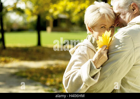 Park, Senior couple, falls in love, embrace, detail, senior citizens, couple, Best Age, cheerfulness, happy, love, affection, partnership, leisure time, leisurewear, vitality, go for of a walk, collect leaves, foliage, maple leaves, hold, season, autumn, Stock Photo