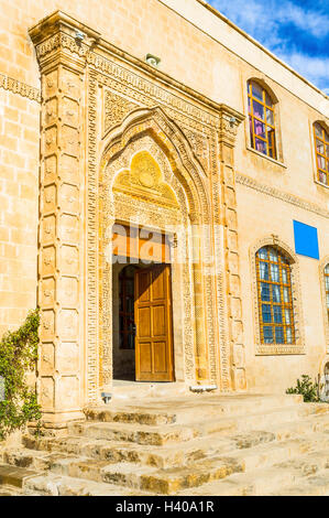 The entrance to the Muzafferiye Madrasa decorated with the carved stone in arabic stule, Mardin, Turkey. Stock Photo