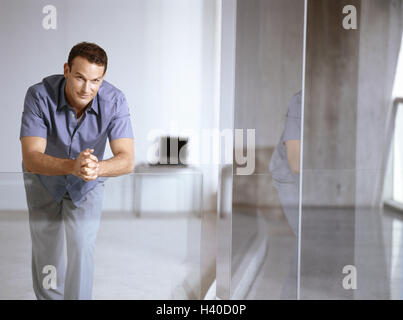 Office buildings, hall, office worker, stand, work break, smile, business premises, hall, walk, glass railing, rest on, man, young, break, rest, recover, wait, patiently, satisfaction, balance, calmness, Confidently, inside Stock Photo