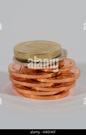 Stack of shiny, copper and silver coins ( 2p, 20p, £1) seen in close-up - this money (sterling) is current UK currency. Stock Photo