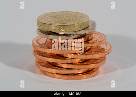 Stack of shiny, copper and silver coins ( 2p, 20p, £1) seen in close-up - this money (sterling) is current UK currency. Stock Photo