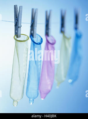 Clothesline, clamps, condoms, hang, Still life, material recording, studio, rope, cable, clothes pegs, prevention, security, contraception, condom, AIDS risk, danger of infection, disease, protection, health, colours, differently, brightly, spectral filte Stock Photo