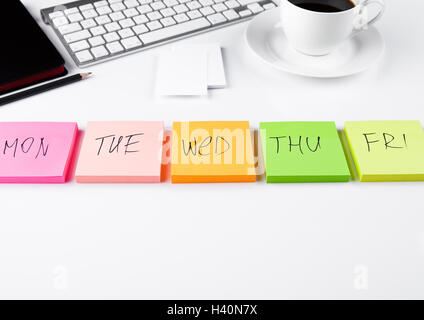 White keyboard with glasses and sticky note papers on white background Stock Photo