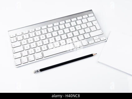 White office computer keyboard with black pencil white background table Stock Photo