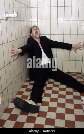 Chill house, tiled, man, suit, shout, desperation, helplessness, slaughter-house, 30-40 years, sit, feebly, exited, loneliness, discouragement, problem, depressions, confusion, oppression, emotional outburst, fear, feelings, emotion, lunacy, enclosed, fit Stock Photo