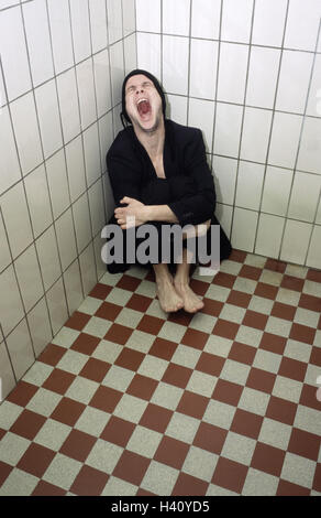 Chill house, tiled, man, suit, shout, desperation, helplessness, slaughter-house, 30-40 years, sit, squatted, feebly, exited, loneliness, discouragement, problem, depressions, confusion, oppression, fear, feelings, emotion, lunacy, enclosed, emotional out Stock Photo