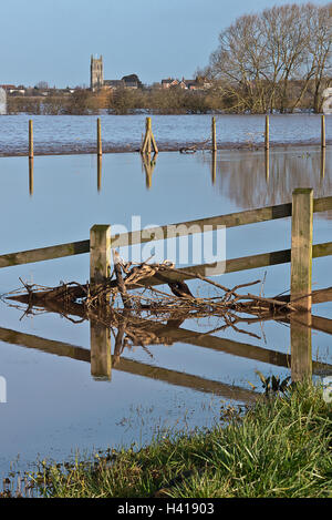 A view cross the still waters of the River Tone and  the flooded Hook Moor beyond with the church at East Lyng in the background Stock Photo